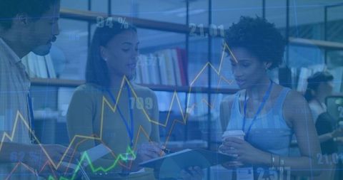 Colleagues Reviewing Financial Data Overlaid in Office Setting