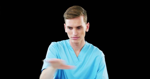 Young Male Healthcare Professional in Scrubs Holding Out Hand - Download Free Stock Images Pikwizard.com