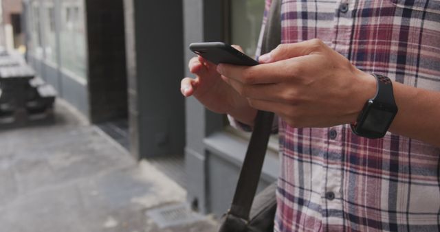 Young Person Using Smartphone Outdoors in Urban Setting - Download Free Stock Images Pikwizard.com