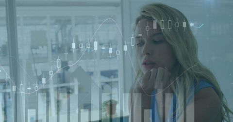 Businesswoman analyzing digital stock charts in office