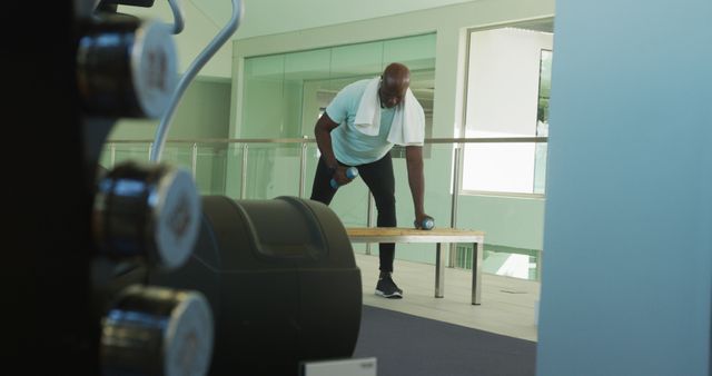 Man Lifting Weights in Modern Gym Setting - Download Free Stock Images Pikwizard.com