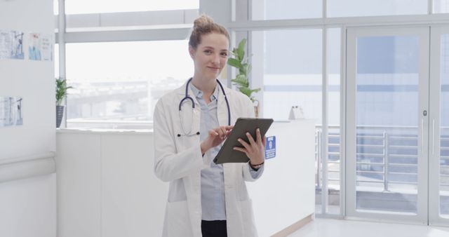 Smiling Female Doctor Using Tablet in Modern Hospital - Download Free Stock Images Pikwizard.com