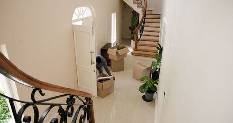 Couple Moving Boxes Into New Home Together