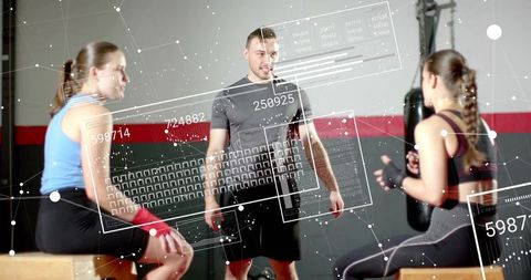 Gym coach leading boxing hiit with punching bag and real-time hud performance analytics