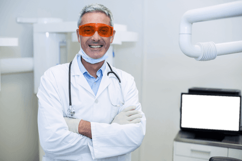 Transparent Confident Dentist Posing in Modern Clinic
