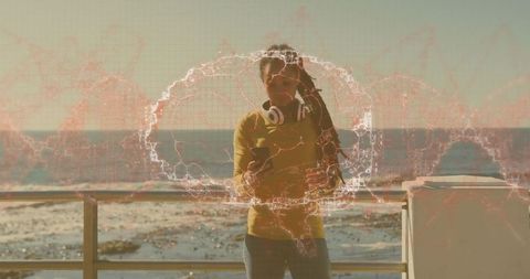 Woman Engages with Technology at Sea Promenade