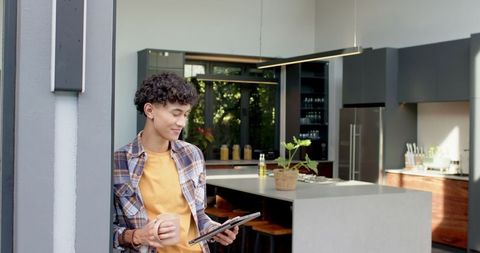 Modern Kitchen Interaction with Digital Tablet and Coffee