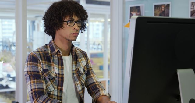 Young Professional Focused at Computer in Modern Office Environment - Download Free Stock Images Pikwizard.com