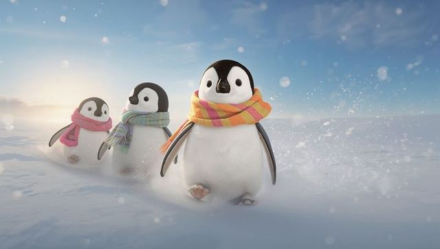 Playful penguin chick trio wearing colorful scarves trotting across snowy arctic sunrise