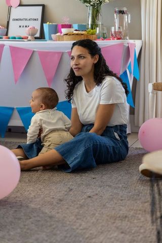 Mother and Baby Celebrating with Joyful Decorations at Home Event