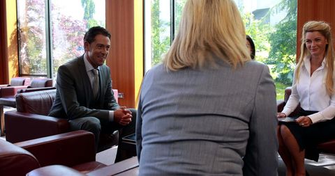 Corporate professionals in formal office meeting with copy space