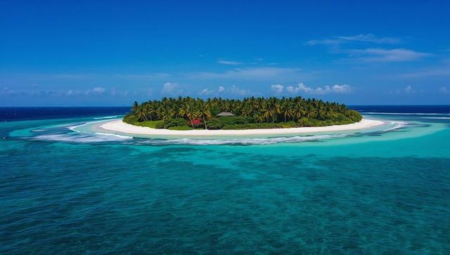 Floating Ring-Shaped Tropical Island with White Sand, Palm Trees and Secluded Bungalow