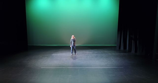 Solo Performer on Stage with Green Spotlight - Download Free Stock Images Pikwizard.com