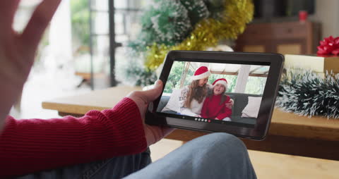Family Enjoying Christmas Video Call on Tablet
