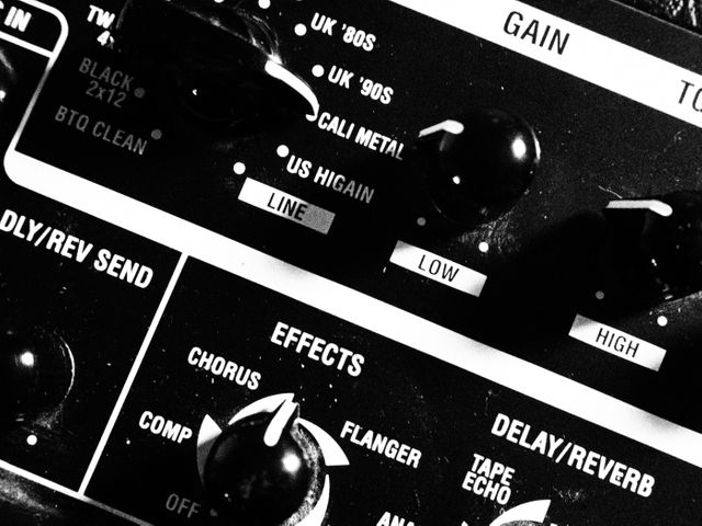 This close-up showcases an electric guitar effects pedal, highlighting various settings like gain levels, chorus, flanger, and delay/reverb. Suitable for articles on music production, gear reviews, professional equipment, or educational content on using guitar effects. Ideal for musicians, music producers, and music enthusiasts.