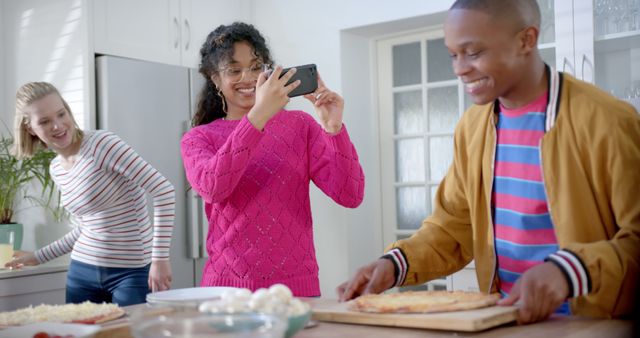 Friends Enjoying Cooking and Taking Photos Together in Modern Kitchen - Download Free Stock Images Pikwizard.com