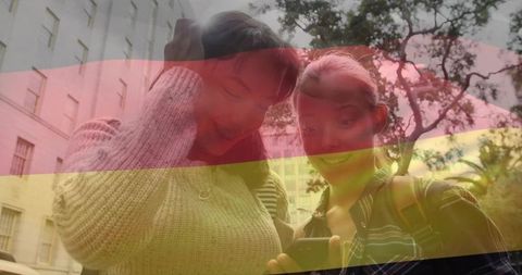 Teen friends appearing amazed watching smartphone in open campus area