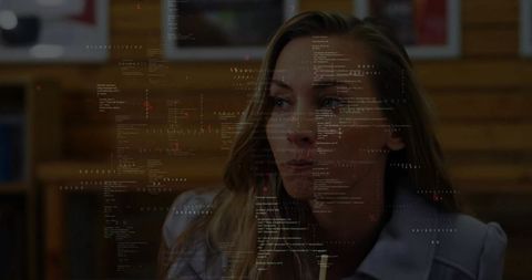 Woman Analyzing Code Overlay in Professional Office Setting