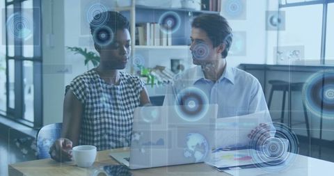 Professionals Analyzing Holographic Data at Modern Office Desk