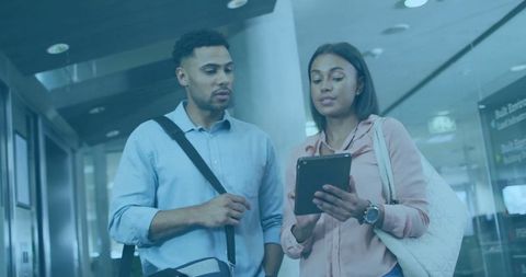 Couple Using Tablet in Airport Departure Lounge