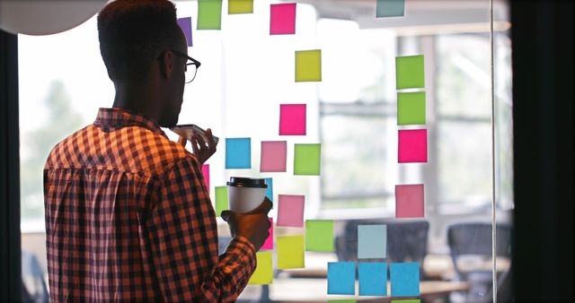 Businessman Brainstorming with Sticky Notes in Modern Office - Download Free Stock Images Pikwizard.com