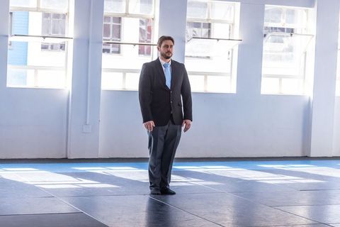 Businessman in training hall with bright windows