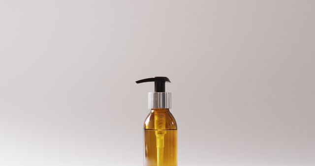 Amber glass pump bottle containing oil on minimalist white background. Ideal for beauty product presentations, skincare advertisements, luxury cosmetic packaging displays, and self-care promotional materials.