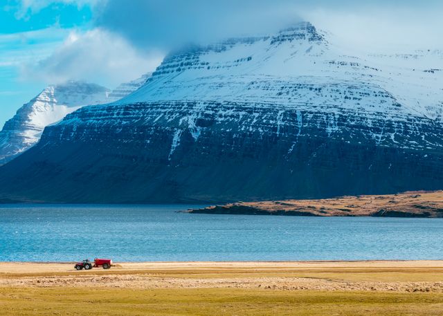 Snow-capped Mountains and Tractor Near Serene Lake in Icelandic Countryside - Download Free Stock Images Pikwizard.com