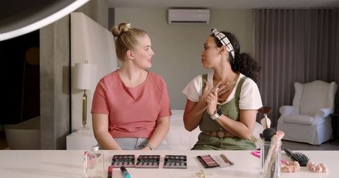 Diverse friends filming makeup tutorial in home studio