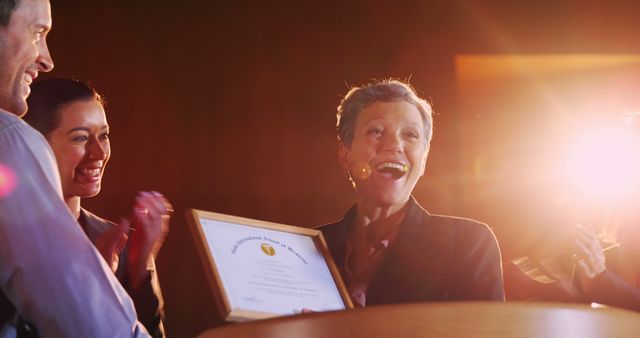 Senior woman receiving award with one person clapping enthusiastically - Download Free Stock Images Pikwizard.com