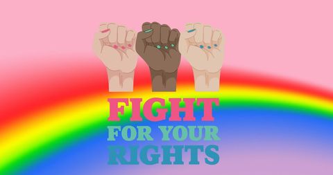 Empowered women's fists above rainbow celebrating equality