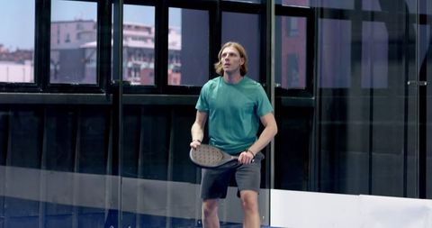 Focused Athlete Playing Padel in Modern Sports Facility