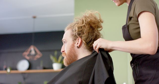 Woman Preparing Client for Haircut in Modern Salon - Download Free Stock Images Pikwizard.com