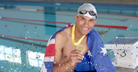 Triumphant Swimmer Holding Gold Medal with Australian Flag