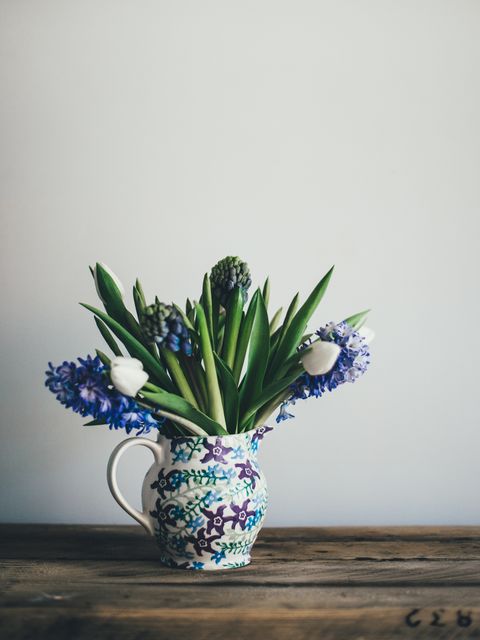 Beautiful Hyacinth Arrangement in Floral Ceramic Pitcher on Wooden Table - Download Free Stock Photos Pikwizard.com