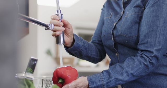 Person Washing Red Bell Pepper Under Running Water in Kitchen - Download Free Stock Images Pikwizard.com