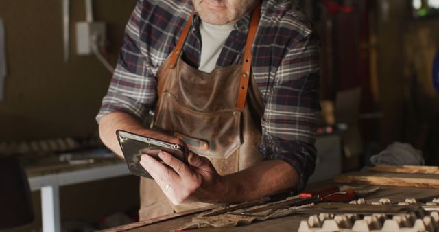 Focused Caucasian Male Knife Maker Using Tablet in Workshop - Download Free Stock Images Pikwizard.com