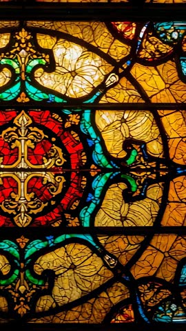 Vertical scan revealing ornate chapel stained glass with gold cross and floral scrollwork
