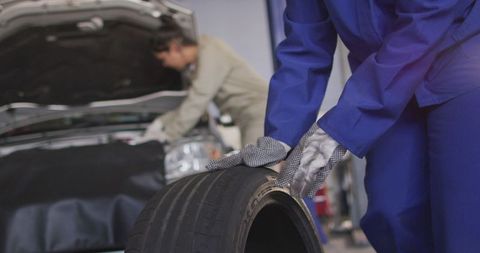 Female Car Mechanics Changing Tire in Auto Repair Shop - Download Free Stock Images Pikwizard.com
