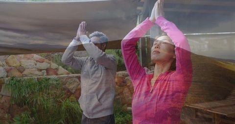 Couple Practicing Yoga Meditation Outdoors in Serene Environment