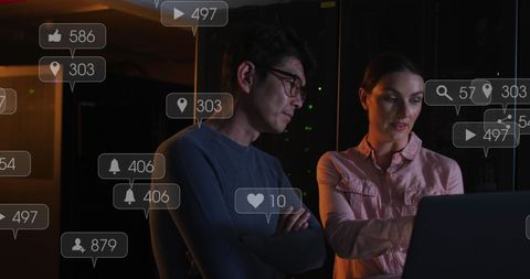 It technicians analyzing data on laptops with social media overlay