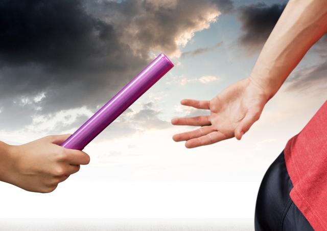 This image shows the hands of two athletes passing the baton during a race, set against a dramatic sky background. Ideal for illustrating concepts of teamwork, sports competitions, and transitions. It can be used in sports articles, motivational posters, advertisements for athletic events, and team-building materials.