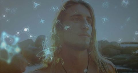 Pensive Man on Rocky Shore with Etherial Starry Aura