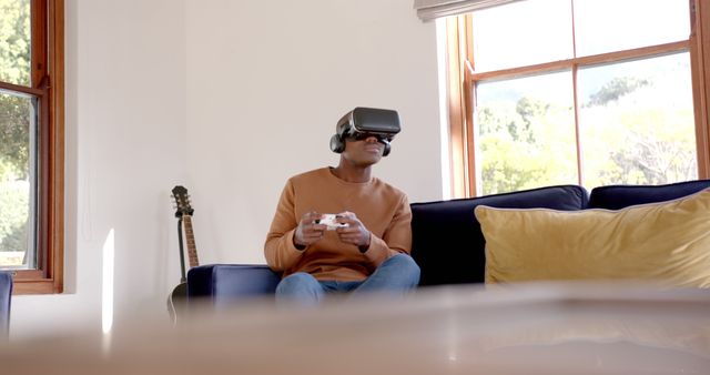 Young Man Playing Virtual Reality Games on Comfortable Couch - Download Free Stock Images Pikwizard.com
