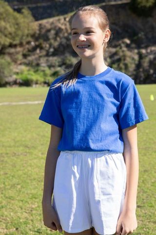 Smiling child in sportswear enjoying sunny day outdoors