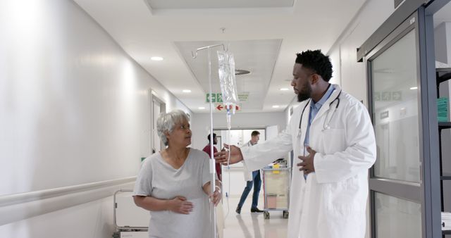 Doctor Assisting Elderly Woman in Hospital Corridor - Download Free Stock Images Pikwizard.com