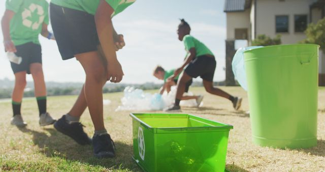 Children are participating in an outdoor environmental cleanup, focusing on recycling and removing litter. This can be used for articles about community service, environmental education, sustainability programs, or promoting volunteer activities for young people.