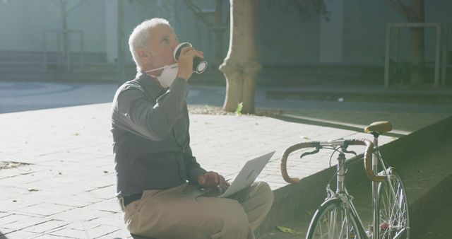 Senior Man Drinking Coffee While Working on Laptop Outdoors - Download Free Stock Images Pikwizard.com