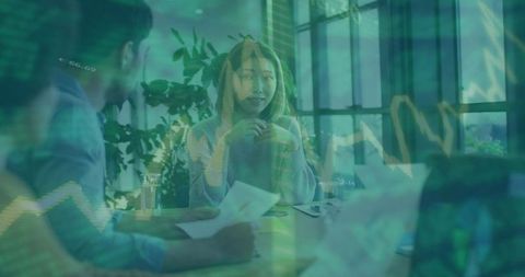 Woman leading team meeting with financial charts overlay, collaboration and strategy