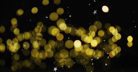 Golden Bokeh Lights with Sparkling Stars on Black Background